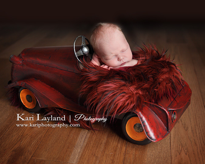 Baby boy in red car