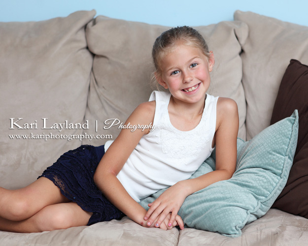 Little girl lounging on couch.  Portrait using bounced flash.