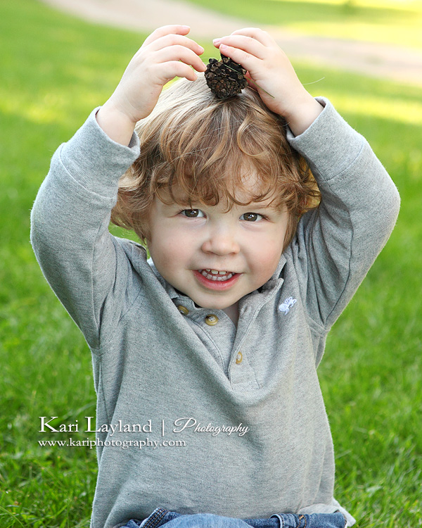 Portrait of a  little boy with a pine cone on his head. Taken in Minnetonka MN at the apple orchard.