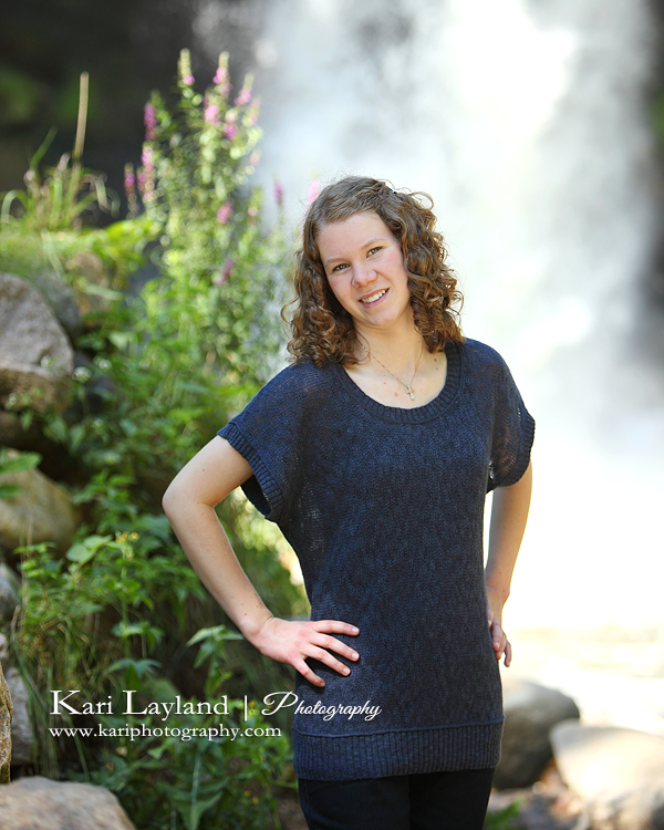 Senior portrait in front of a waterfall in Minneapolis MN.  Taken by Kari Layland Photography