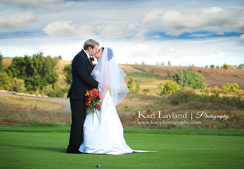 Bride and Groom kissing on golf course