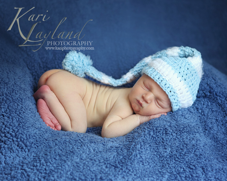 Baby posing on belly, photography by Kari Layland, MN newborn photographer
