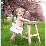Baby girl standing portrait outdoors MN