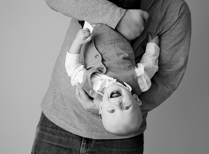 Candid playful 1 yr baby portrait with dad taken by MN photographer Kari Layland.